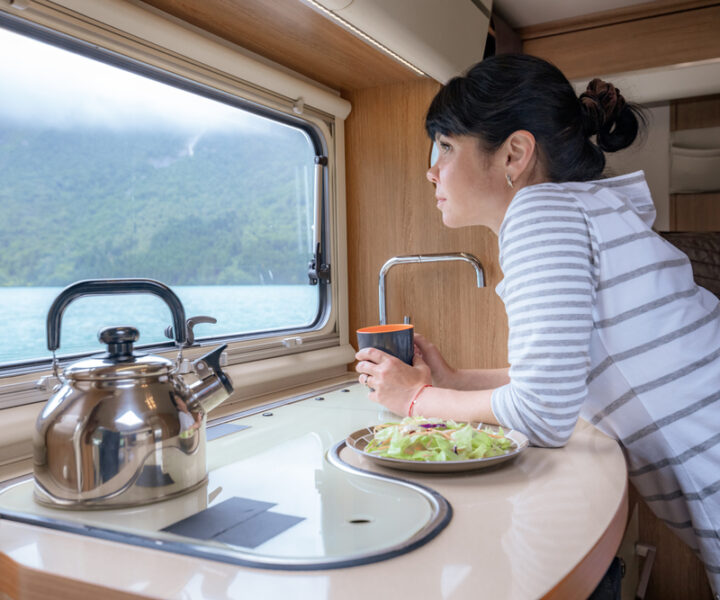 Woman,In,The,Interior,Of,A,Camper,Rv,Motorhome,With